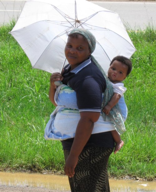 This Mom asked me for a job... Women carry umbrellas for protection from the sun